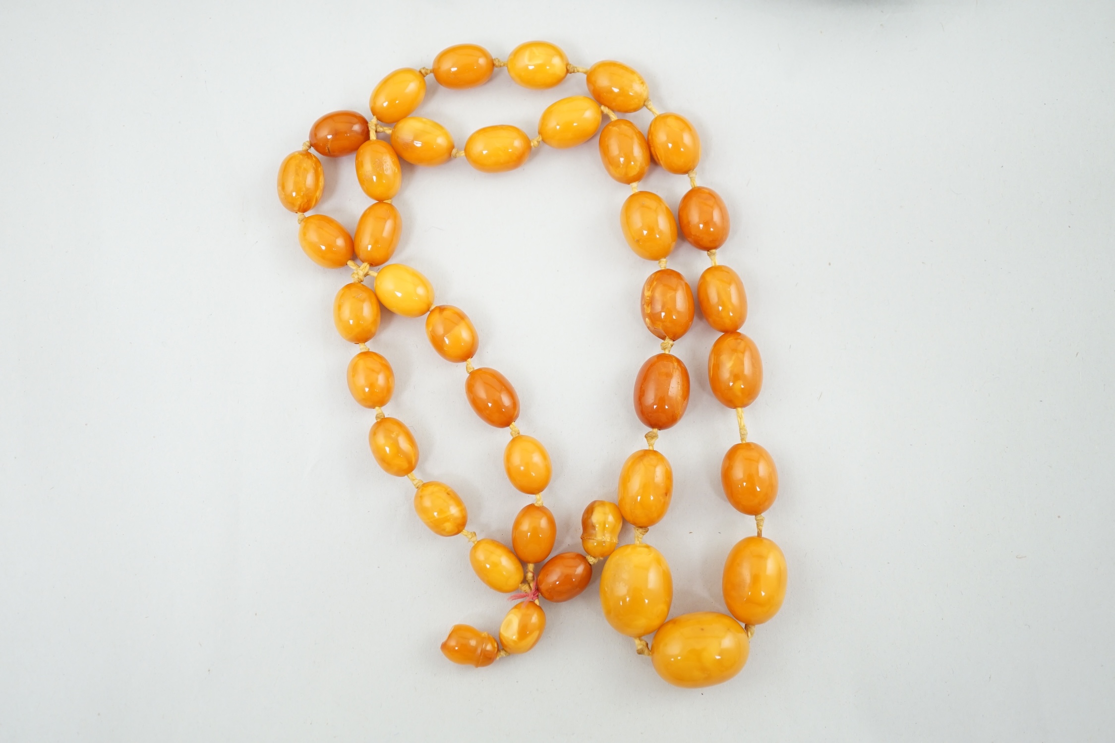 A single strand graduated oval amber bead necklace